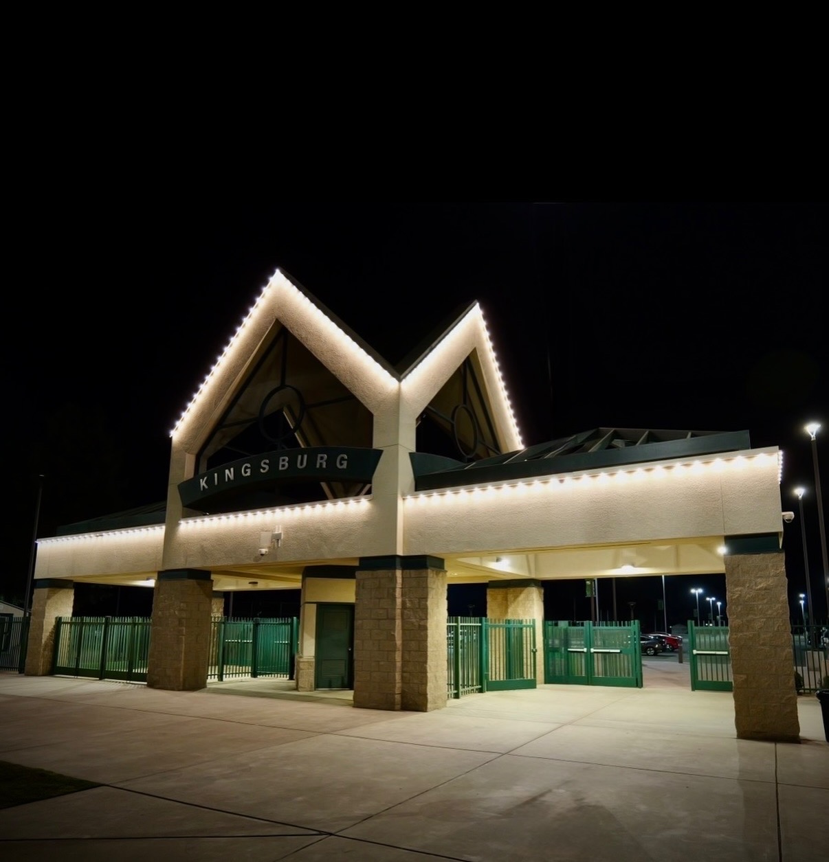 Kingsburg entrance pavilion outlined in clean warm white lights at night