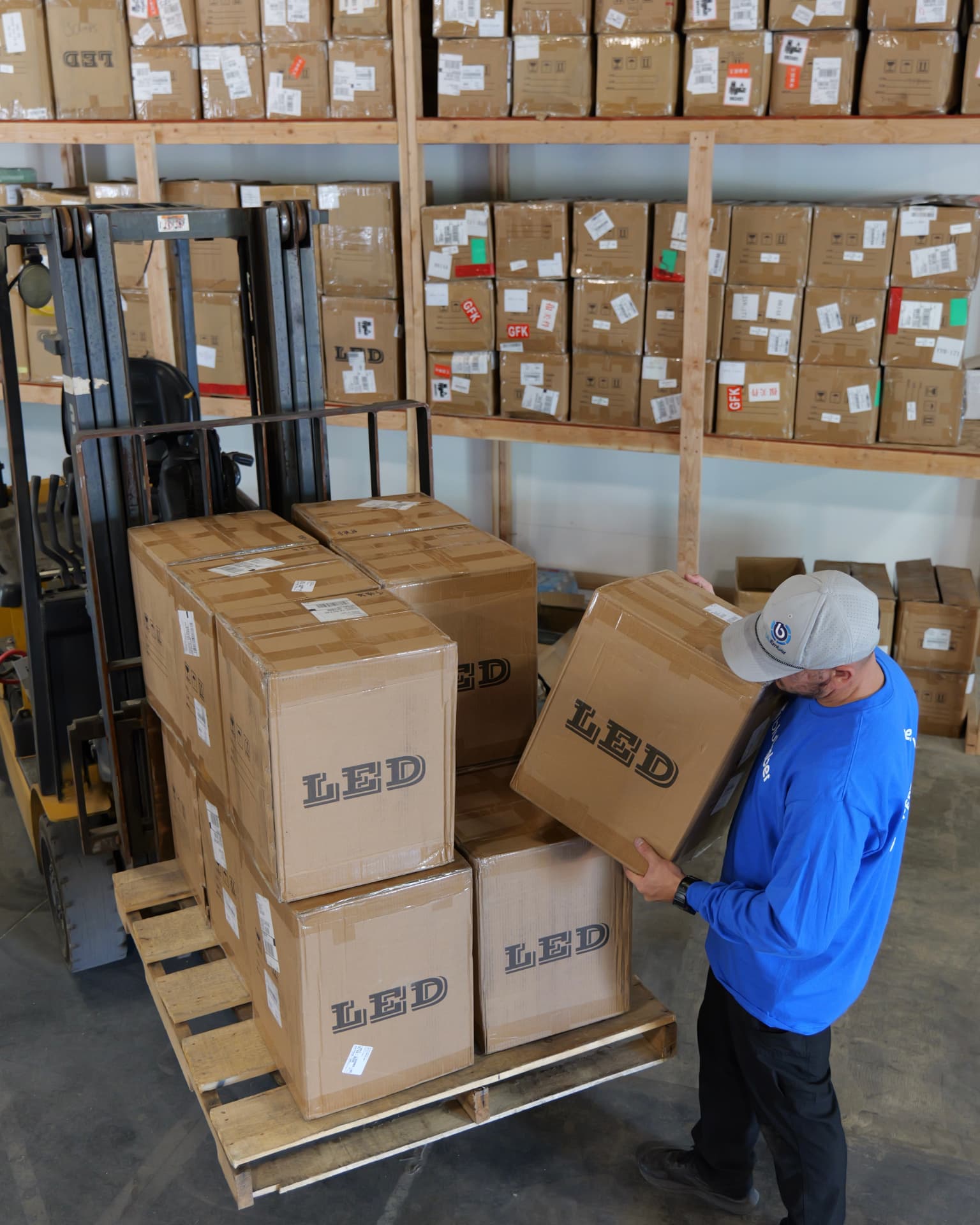 A bluEmber team member loading palletized product in the Clovis warehouse