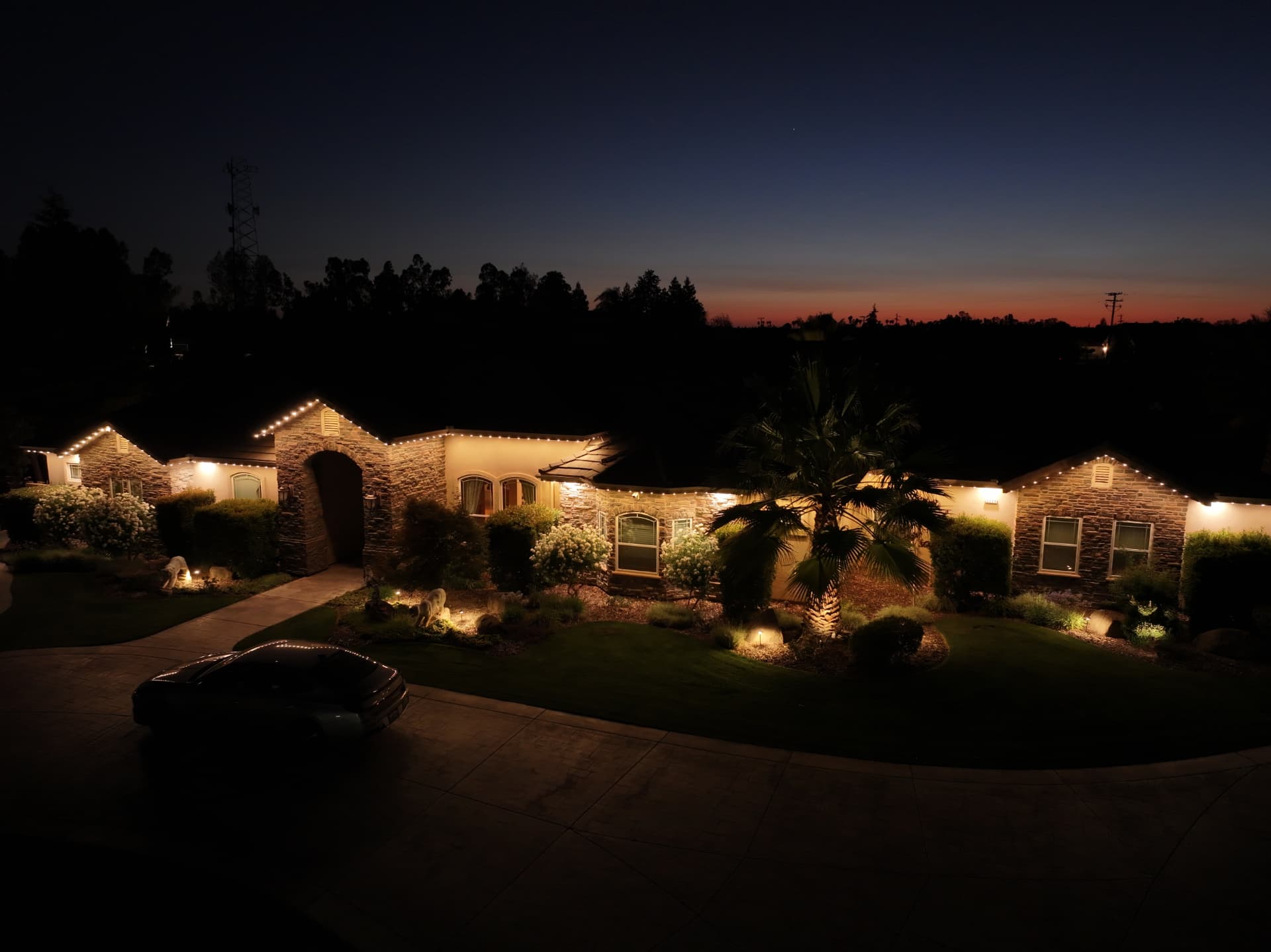 Home at dusk with warm-white bluEmber roofline lighting