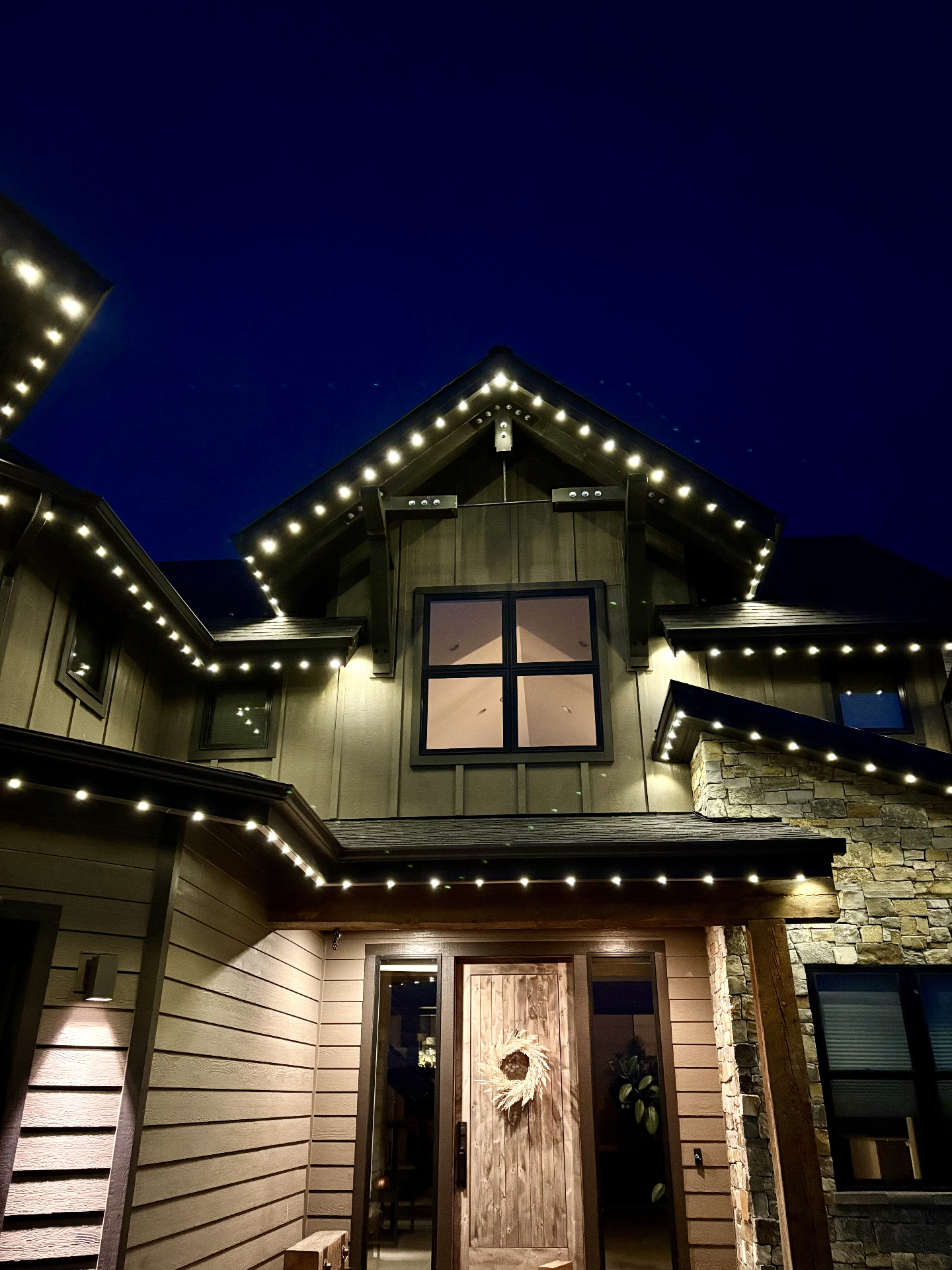 Close-up of warm-white bluEmber lights along a home's eaves