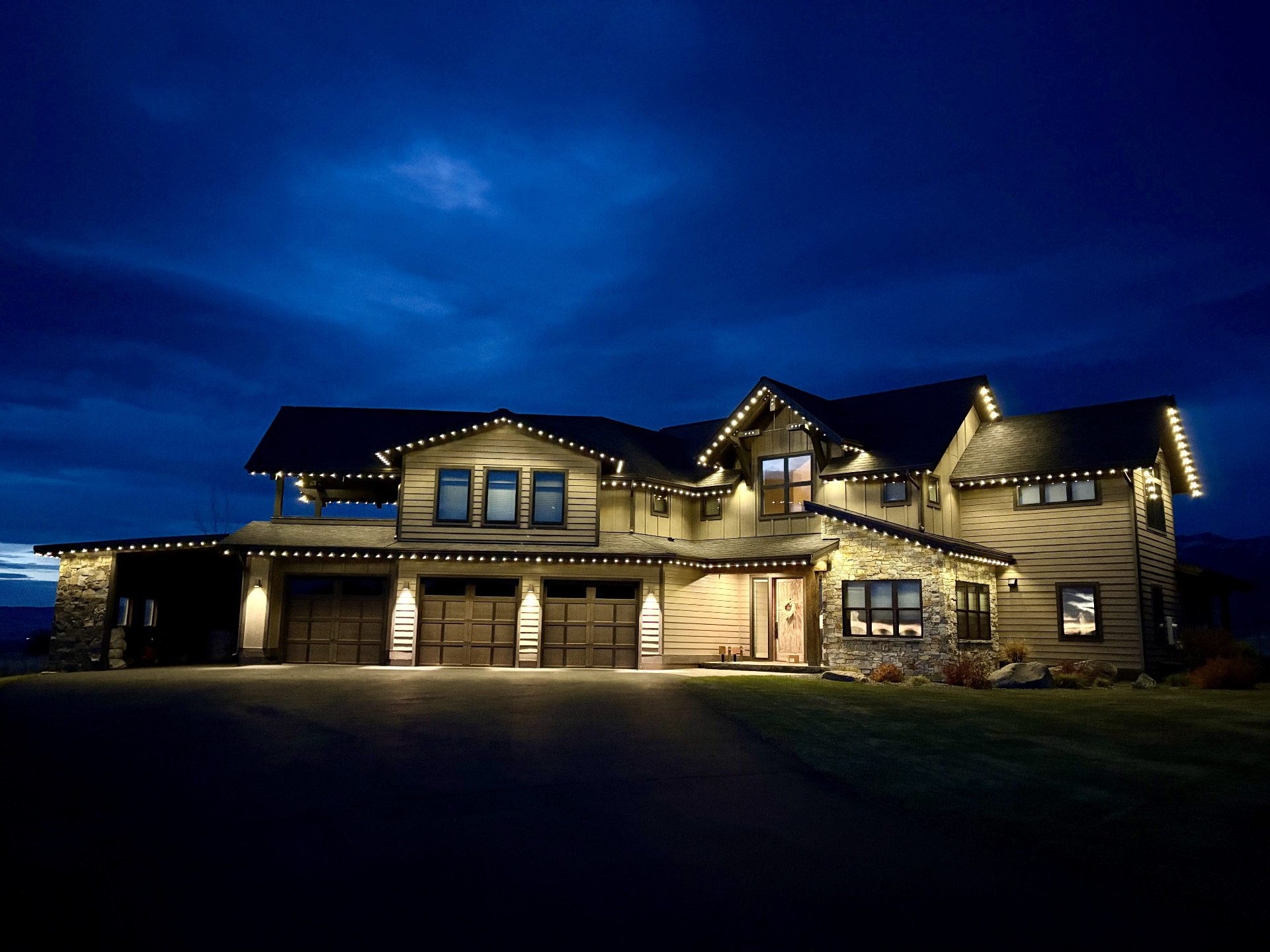 Montana mountain home outlined in warm-white bluEmber permanent lights