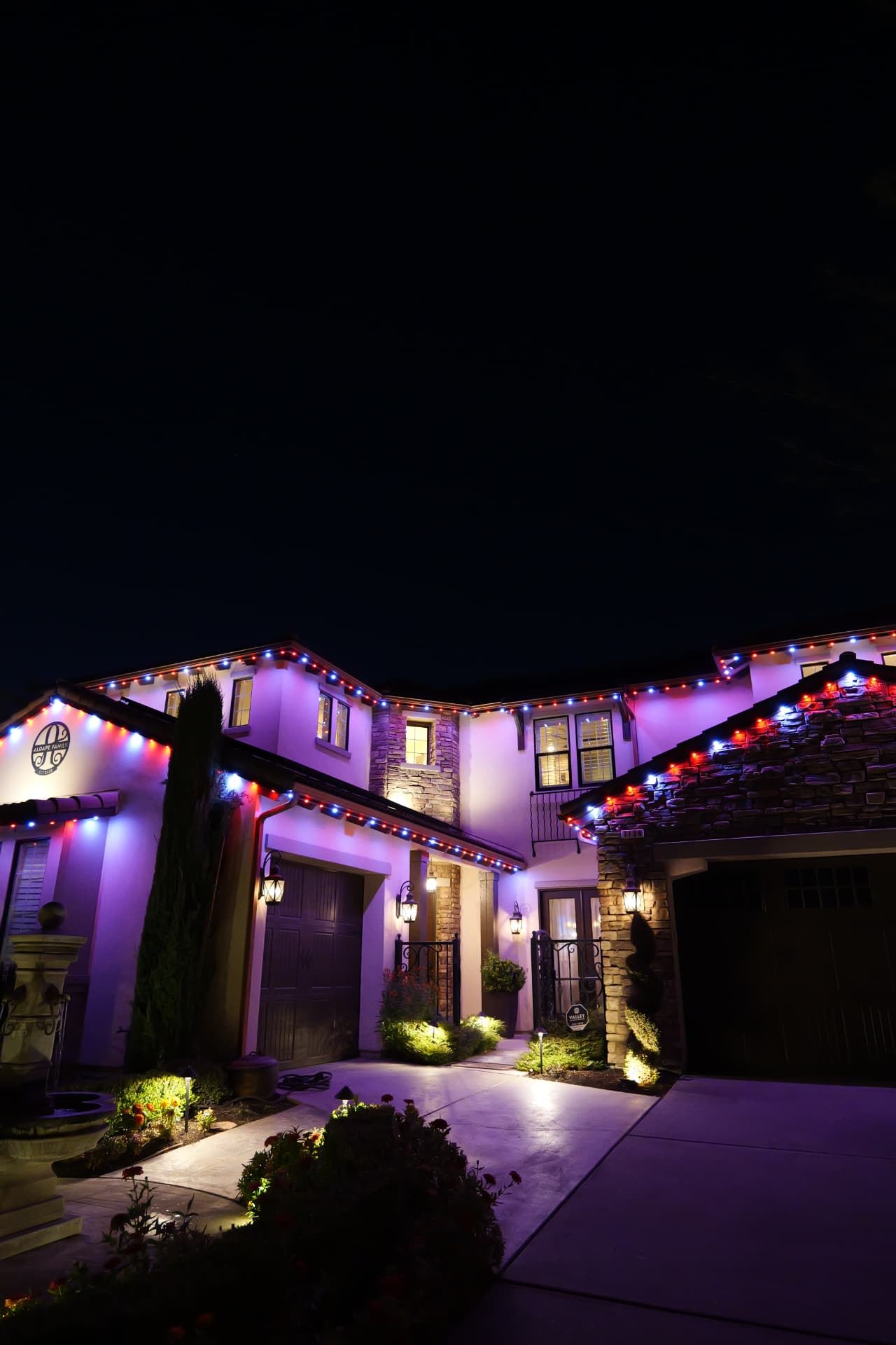 Two-story home in red, white, and blue bluEmber patriotic lighting